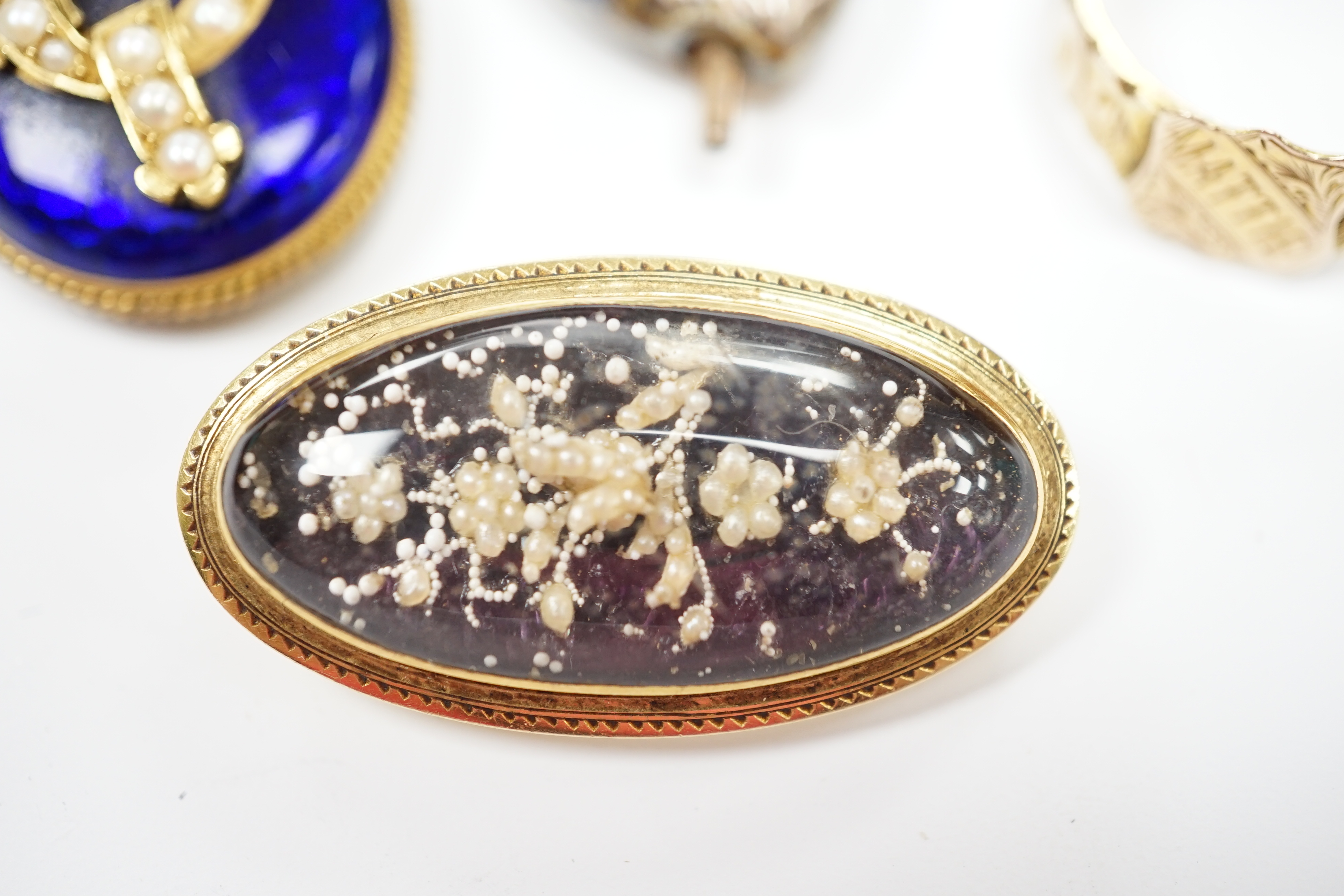A Victorian yellow metal, blue enamel, seed pearl and rose cut diamond set oval pendant, with glazed back, 28mm, a late Victorian 9ct gold signet ring, engraved Mattie, a glazed yellow metal, enamel and seed pearl oval b